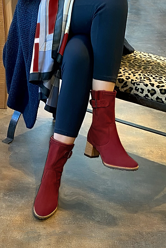 Burgundy red women's ankle boots with buckles on the sides. Round toe. Medium block heels. Worn view - Florence KOOIJMAN